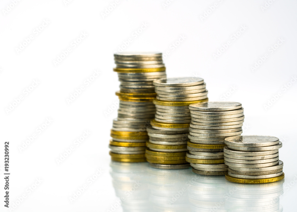 Macro shot detail of golden and silver color coin stacks on white background with copy space for text. Business and finance growth, saving money, investment and interest concept. Macro shot detail of golden and silver color coin stacks on white background with copy space for text. Business and finance growth, saving money, investment and interest concept.