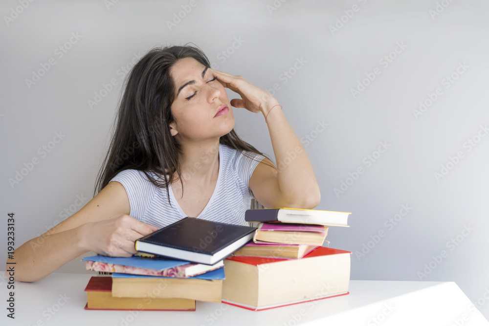 Tired Student Woman with Headache Studying for Exams Tired Student Woman with Headache Studying for Exams