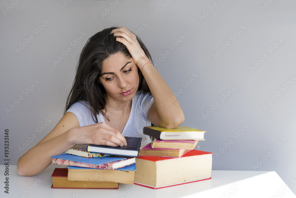 Tired and Sad Student Woman with Books Worried about Exams Tired and Sad Student Woman with Books Worried about Exams