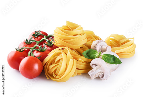 Raw tagliatelle pasta, champignon, cherry tomatoes and basil isolated on white background.