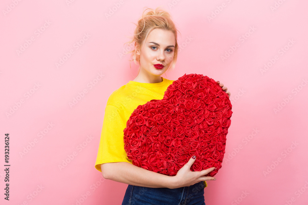 Attractive woman hold big red flower heart