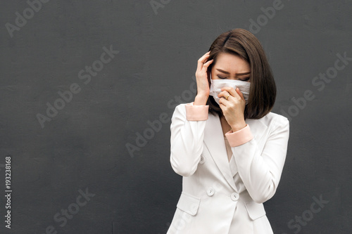 Asian woman wear protective face mask in pollution city with coughing., copy space for text