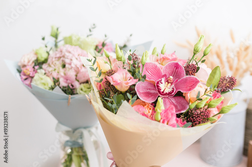 Fototapeta Naklejka Na Ścianę i Meble -  flower shop concept. Close-up beautiful lovely bouquet of mixed flowers on wooden table. Wallpaper
