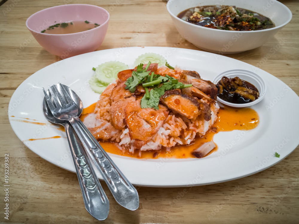 Barbecued red pork in sauce with rice.