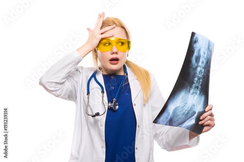 Surprised woman doctor in white coat with X-ray photo