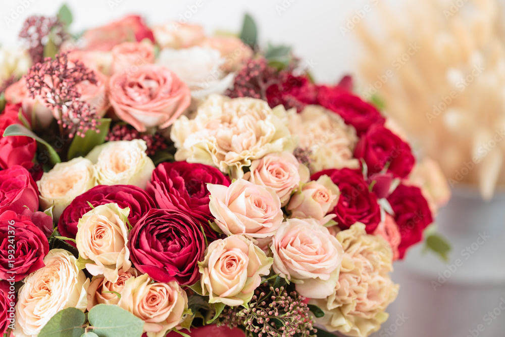 Beautiful luxury bouquet of mixed flowers in red box. the work of the florist at a flower shop. Wallpaper