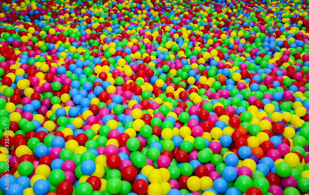 Ball pit with colorful plastic balls in children entertainment center. Pool  with bright balls background. Fun, game, play. Stock Photo | Adobe Stock