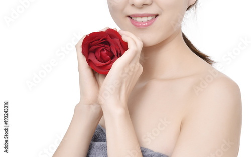 Red rose in woman hands. Smiling pretty woman with a rose. 