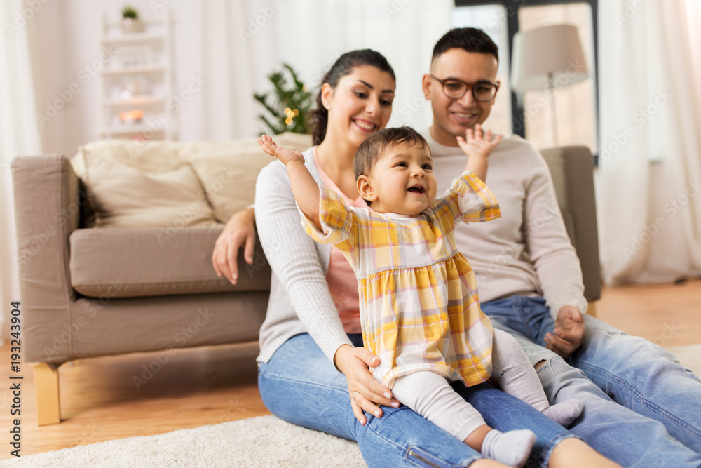 happy family and baby daughter playing at home