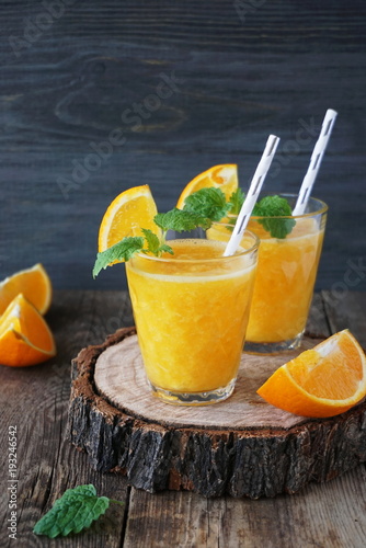 Orange smoothie on a wooden table
