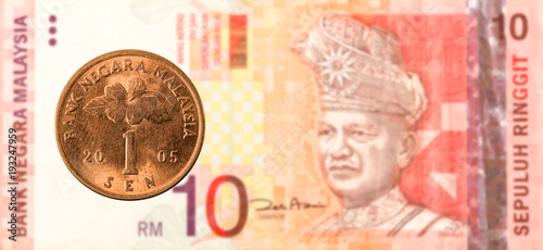 1 malaysian sen coin against 10 malaysian ringgit bank note obverse