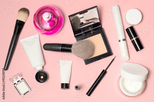 Concept of a white and black cosmetic supplies. Top view on pink background