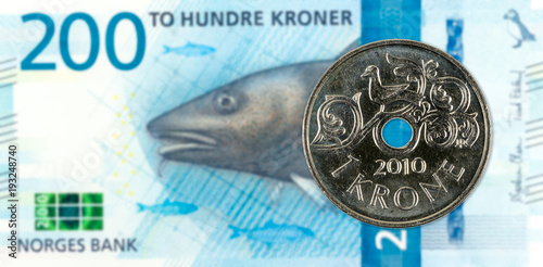 1 norwegian coin against new 200 norwegian krone bank note obverse