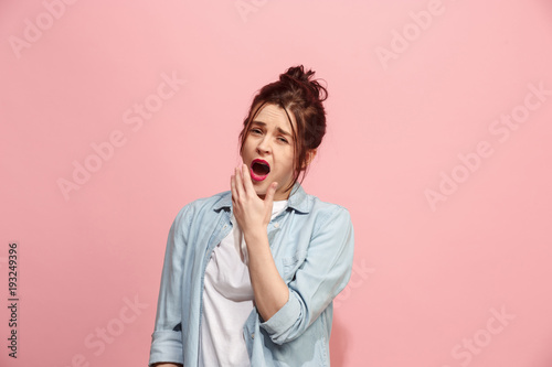 Beautiful bored woman bored isolated on pink background photo