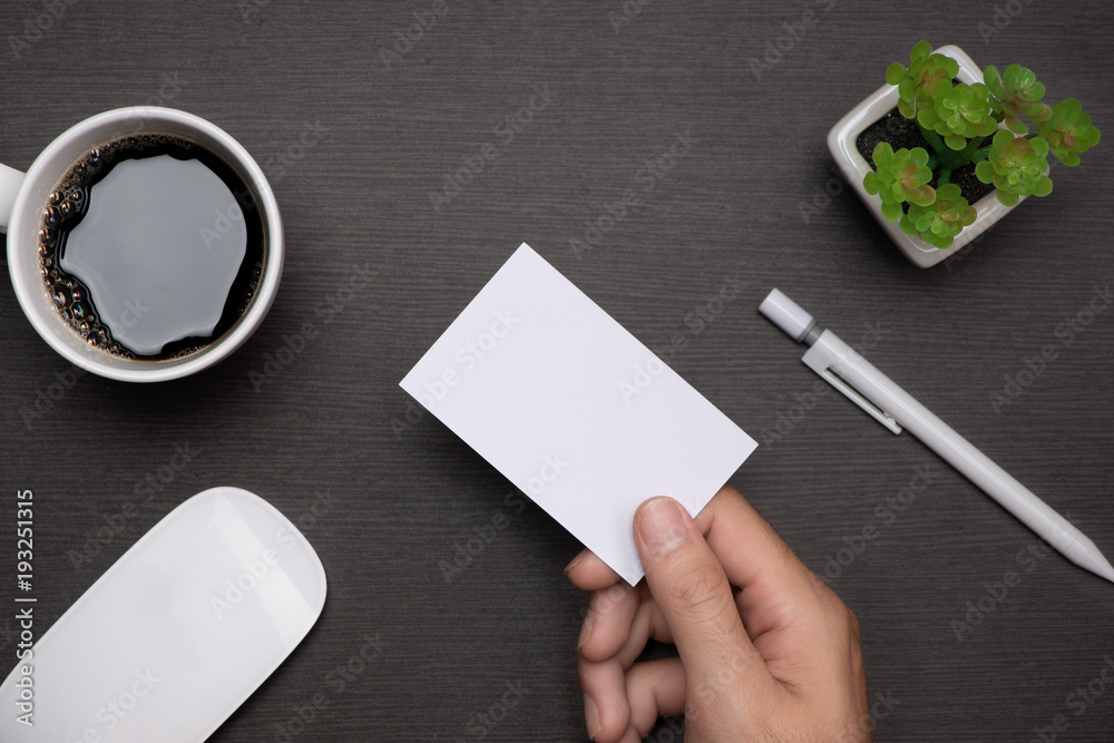 Obraz premium Mockup of white business cards in man's hand