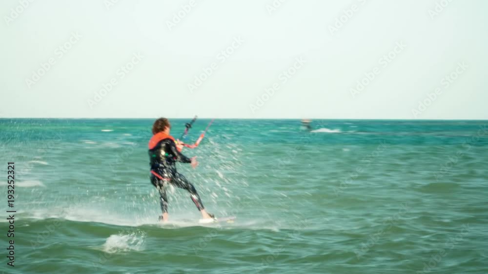 Man Kitesurfing In Ocean In Summer Does Extreme Trick Man Kitesurfing In Ocean In Summer Does Extreme Trick