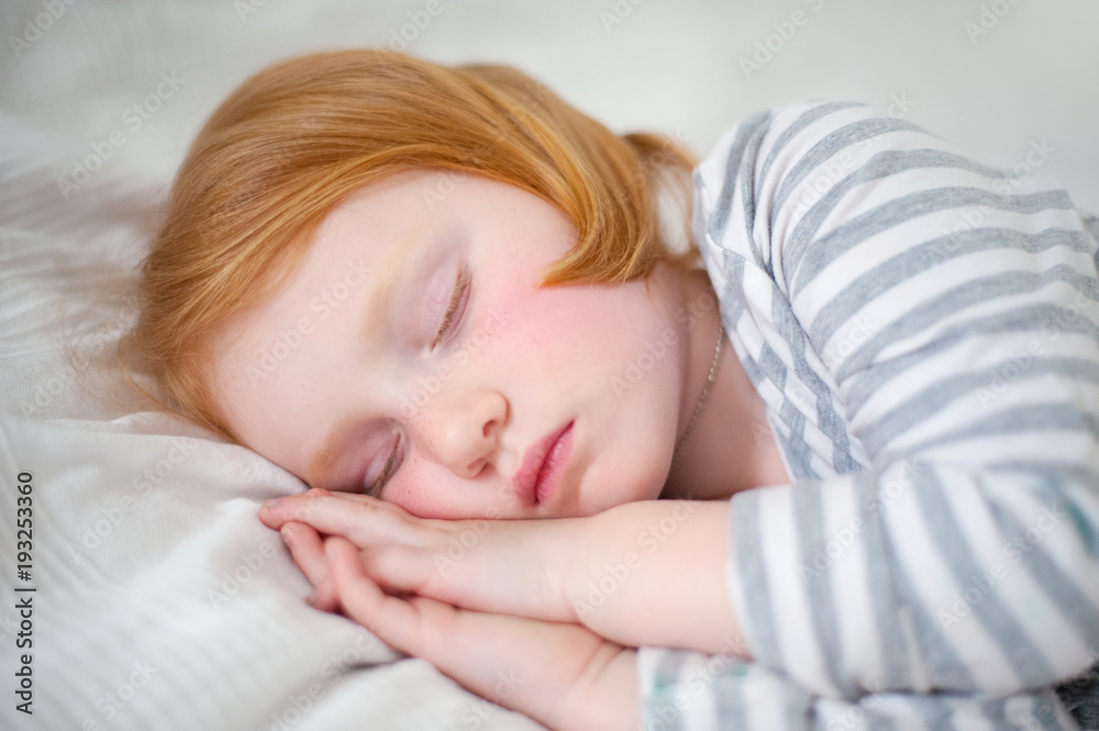 The ruddy girl sleeps with her hands folded under her cheek The ruddy girl sleeps with her hands folded under her cheek