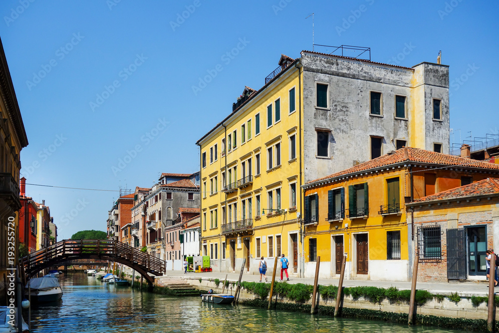 VENICE, ITALY - May 18, 2017 : View of water street and old buildings in Venice on May 18, 2017. its entirety is listed as a World Heritage Site, along with its lagoon