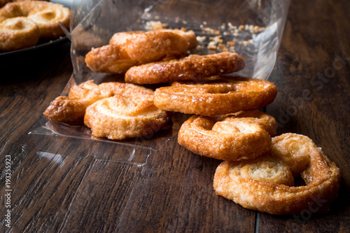 Palmier Cookies in Black Plate on Wooden Surface.