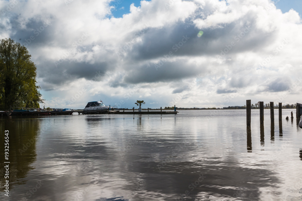 Lake, sky, clouds on the sky and their reflections in the water of the lake