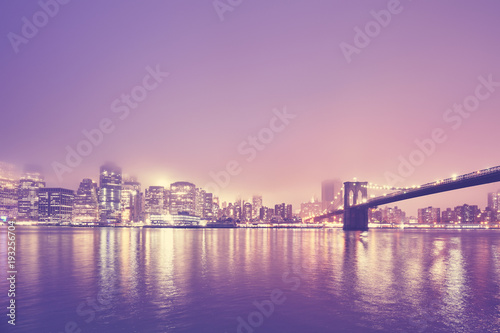 Color toned picture of the Manhattan at a foggy night, New York City, USA.