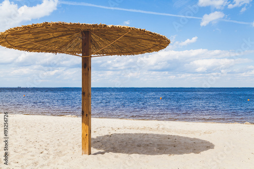 Fototapeta Naklejka Na Ścianę i Meble -  Sunshade on sandy beach on summer day