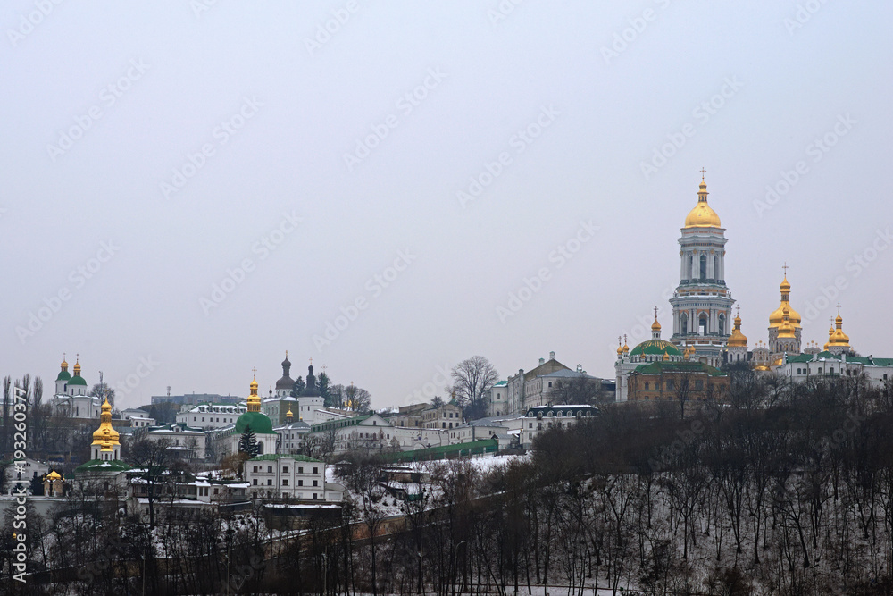 Winter view of Kyievo-Pechers'ka lavra and Belltower on blue sky background. It is a historic Orthodox Christian monastery. Morning landscape photo. Kyiv, Ukraine