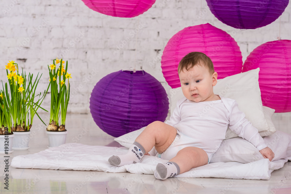 Fototapeta premium little boy sits on the pillow