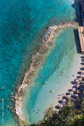 Aerial view of a beach with blue clear water