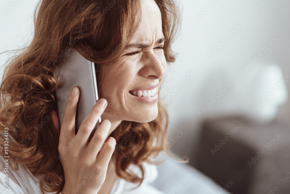 In need of psychological help. Young lady having emotional disorder grimacing while calling somebody during another nervous breakdown. In need of psychological help. Young lady having emotional disorder grimacing while calling somebody during another nervous breakdown.