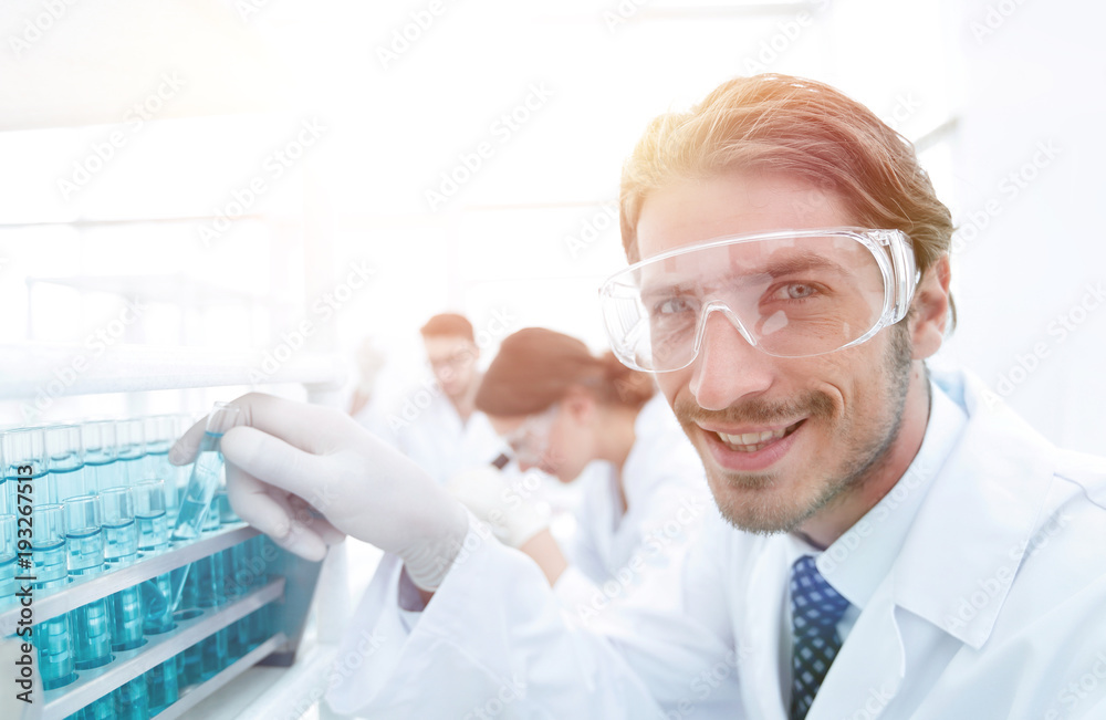 close-up of a happy male scientist wearing safety glasses close-up of a happy male scientist wearing safety glasses