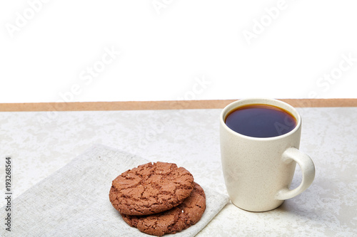 Close-up white cup of coffee with chocolate chip cookies on white background, top view