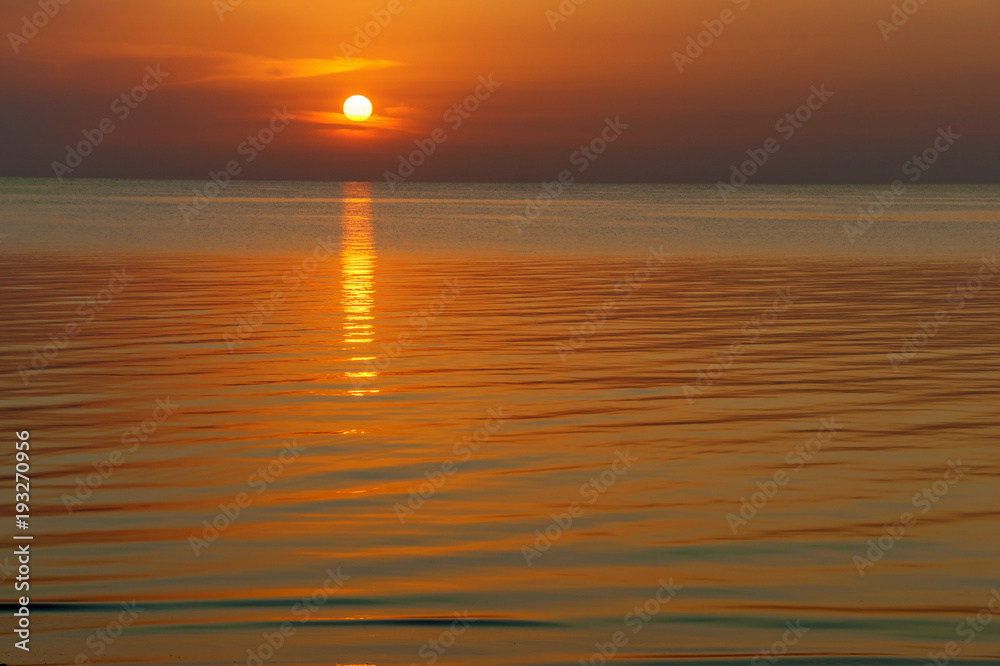 Obraz premium Sunset over the water.