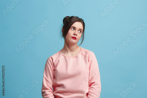 Beautiful bored woman bored isolated on blue background photo