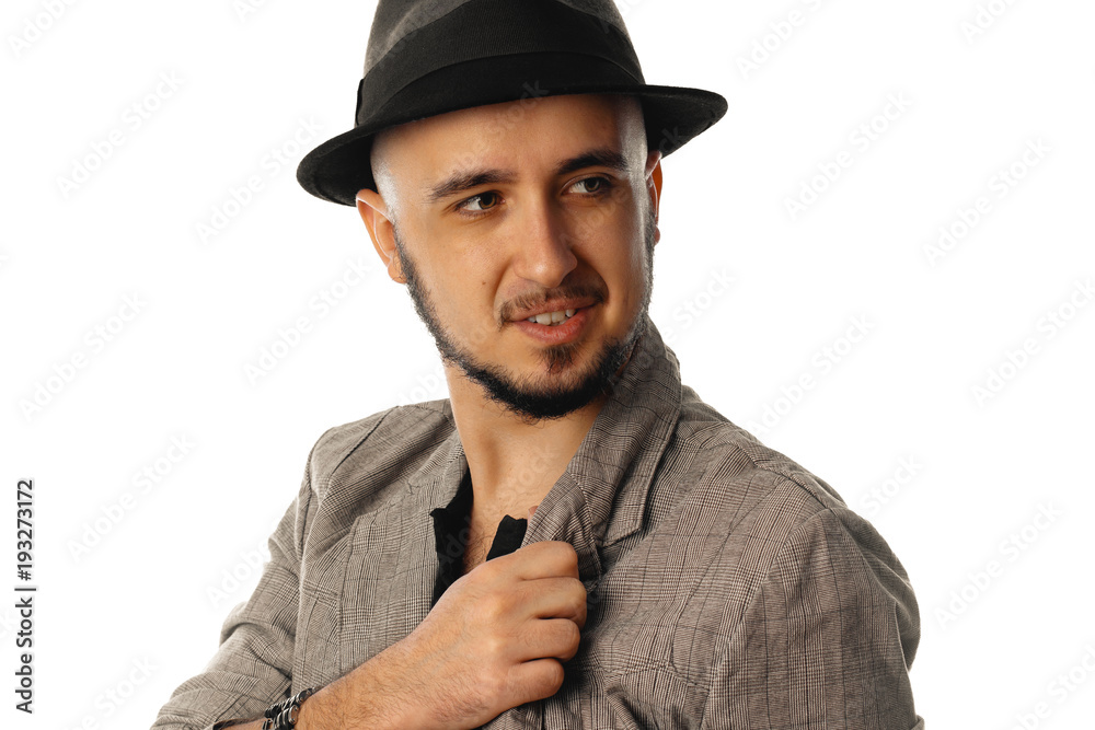 young cheerful man in hat and jacket looking aside young cheerful man in hat and jacket looking aside