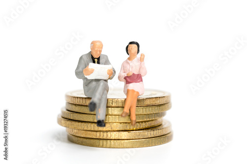Miniature people: Businessman sitting on stack of coin