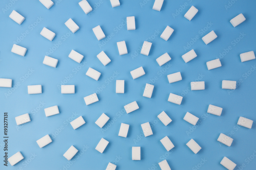 White sugar cubes on blue background