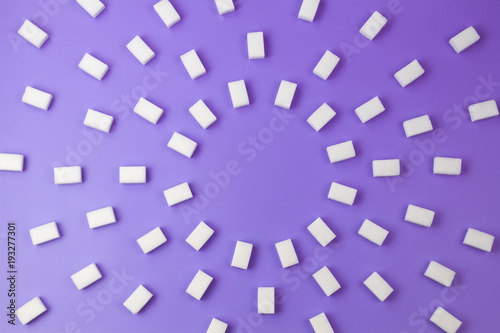 White sugar cubes on purple background