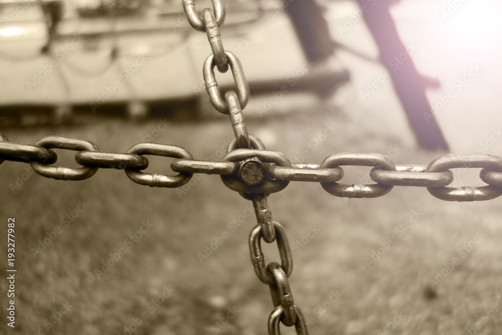 Obraz premium Chains connected by a screw