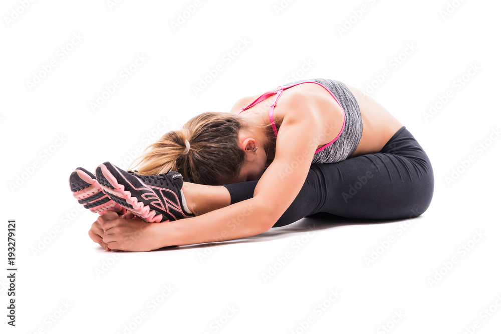 Young fitness model in white sportswear doing yoga or pilates training, seated Forward Bend pose Intense Dorsal Stretch isolated on white Young fitness model in white sportswear doing yoga or pilates training, seated Forward Bend pose Intense Dorsal Stretch isolated on white