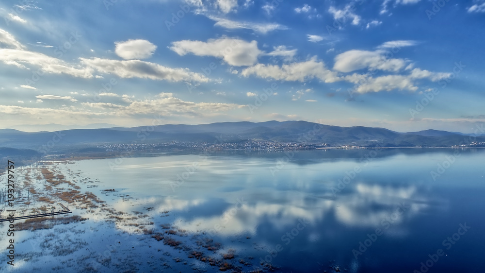 reflection of clouds at the wetland of Lake Doriani on a winter day in northern Greece. atmospheric effect