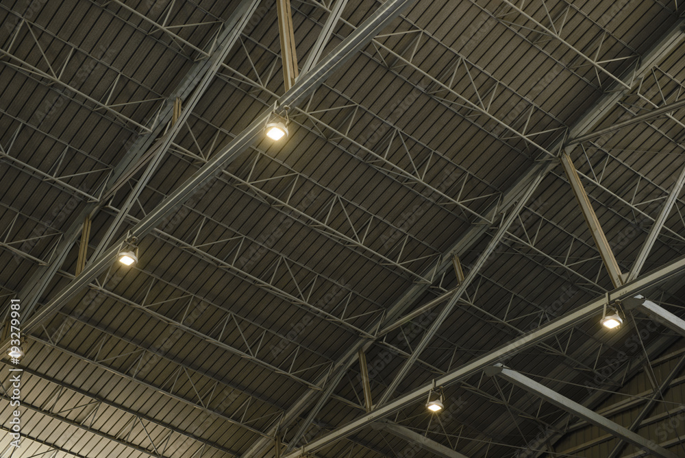 Detail of the structure of a warehouse roof with lamp