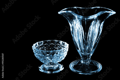 Small glass and vase isolated on black background photo