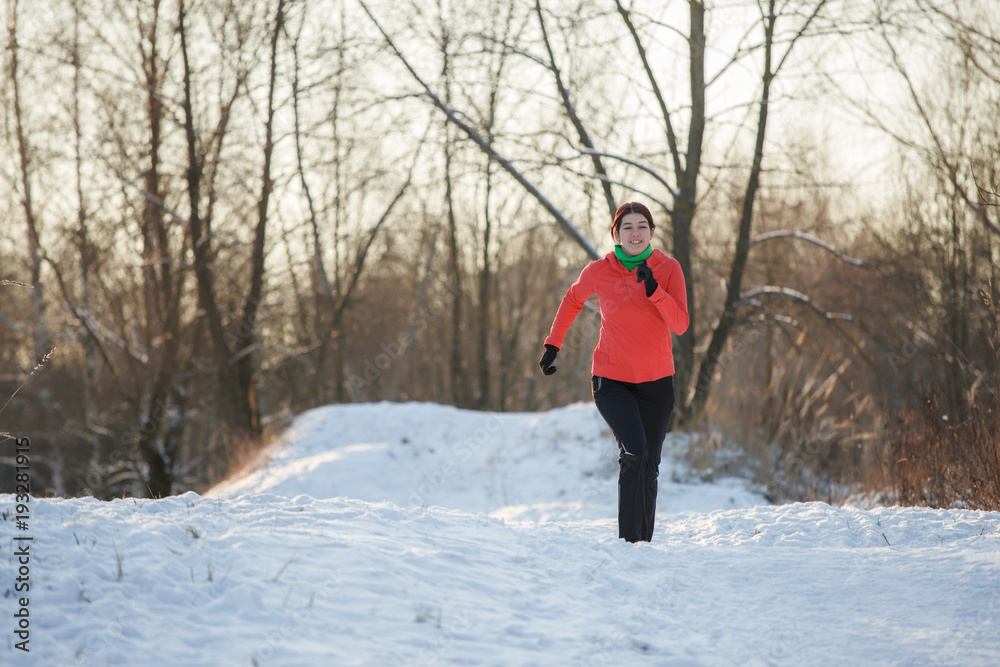 Picture of brunette athlete running in winter park