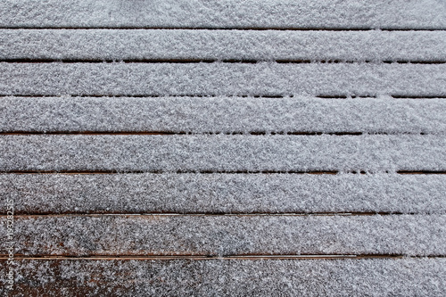 snow on brown wooden background