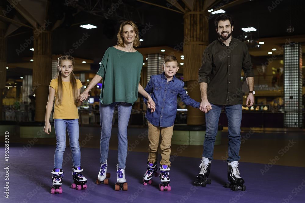 parents and kids skating together on roller rink parents and kids skating together on roller rink
