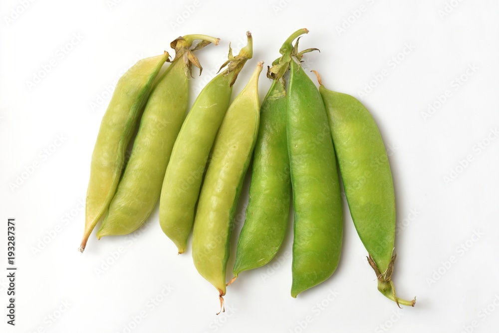 Bright and fresh peas on a white paper background Bright and fresh peas on a white paper background