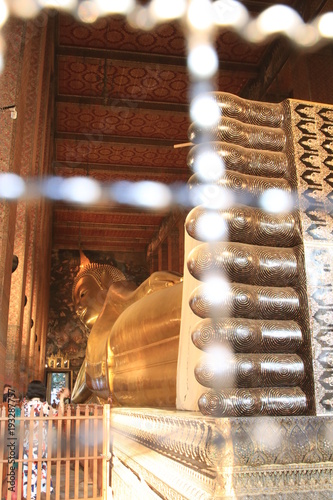 Close up big golden budhha statue in Wat Pho ,Bangkok Thailand photo