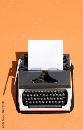 Vintage typewriter with a white blank page