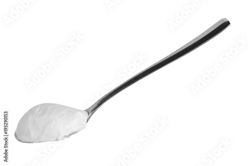 Metal spoon with sour cream isolated, black and white photo